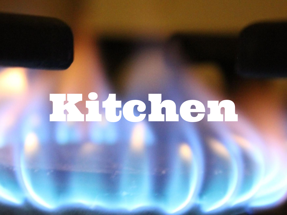 Close up of a lit burner with Kitchen superimposed on top